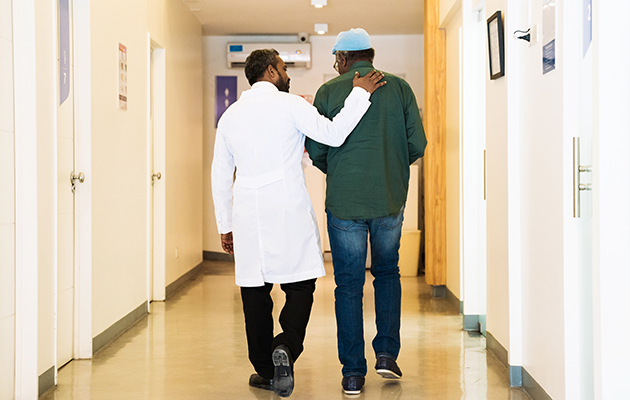 Dr and Patient Walking in a Hospital