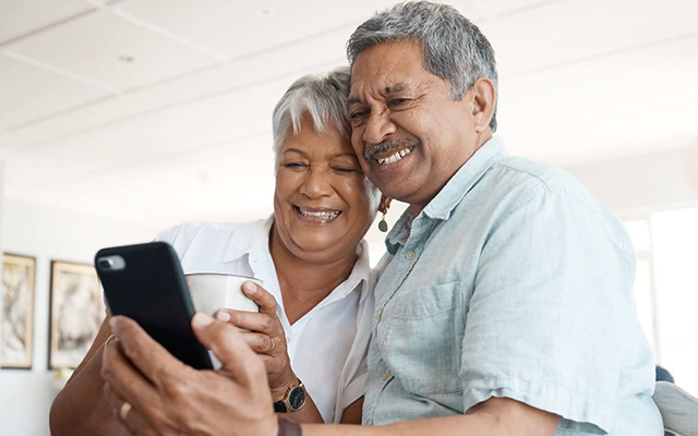 older couple looking at phone together